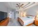 Inviting bedroom showcasing a tray ceiling, fan, neutral carpet and a classic wood bed frame at 3916 Abbott Way # 2, Powder Springs, GA 30127