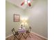 Intimate dining area featuring a table for two, complemented by a ceiling fan and a framed Atlanta cityscape print at 3916 Abbott Way # 2, Powder Springs, GA 30127