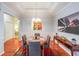 Elegant dining room with tray ceiling, hardwood floors, and stylish furnishings at 3916 Abbott Way # 2, Powder Springs, GA 30127