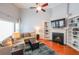 Inviting living room featuring a fireplace with built-in bookshelves and a cozy sectional sofa at 3916 Abbott Way # 2, Powder Springs, GA 30127