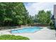 The community pool has plenty of lounge seating, greenery and shady trees at 3916 Abbott Way # 2, Powder Springs, GA 30127