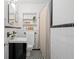 Modern bathroom features a black vanity, black and white tiled floors, and shower/tub combo at 893 Brownwood Avenue Se Ave, Atlanta, GA 30316