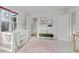 Cozy Bedroom with crib, area rug, art, decorative ladder, bench and access to other areas at 893 Brownwood Avenue Se Ave, Atlanta, GA 30316