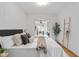 Bright bedroom features white wainscoting, wood floors, decorative ladder and an office space beyond the doorway at 893 Brownwood Avenue Se Ave, Atlanta, GA 30316