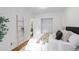 A bright bedroom with white wainscoting, wood floors, closet and a decorative wooden ladder on display at 893 Brownwood Avenue Se Ave, Atlanta, GA 30316