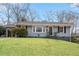 Charming single-story home features a well-manicured lawn, mature trees, and a convenient carport at 893 Brownwood Avenue Se Ave, Atlanta, GA 30316