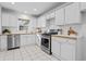 Lovely bright kitchen featuring stainless steel appliances, white cabinets, and tiled floors at 893 Brownwood Avenue Se Ave, Atlanta, GA 30316