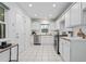 Fresh kitchen with white cabinetry, stainless steel appliances, and an adjacent door to the backyard at 893 Brownwood Avenue Se Ave, Atlanta, GA 30316