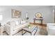 The open living room has hardwood floors, neutral decor and is open to the dining area at 893 Brownwood Avenue Se Ave, Atlanta, GA 30316