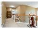 Hallway showcasing a staircase with a wooden railing and a carpeted floor at 995 Brighton Cove Trl, Lawrenceville, GA 30043