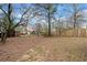 Large, leaf-covered backyard with a shed and some newly installed wood fencing at 10550 Plantation Bridge Dr, Alpharetta, GA 30022