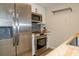 Kitchen showcasing stainless steel appliances, wood countertops, and tile backsplash at 1280 W Peachtree Nw St # 3709, Atlanta, GA 30309