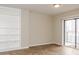 Bright living room featuring a sliding glass door and custom built-in shelving at 1280 W Peachtree Nw St # 3709, Atlanta, GA 30309
