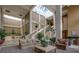 Grand lobby with seating areas, natural light, plants, and staircase at 1280 W Peachtree Nw St # 3709, Atlanta, GA 30309