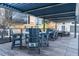 Enjoy outdoor dining under a pergola with tables and chairs on a spacious deck at 1280 W Peachtree Nw St # 3709, Atlanta, GA 30309