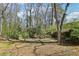 The property features a spacious backyard with a mix of mature trees and lush greenery, perfect for outdoor enjoyment at 3469 Sexton Woods Dr, Atlanta, GA 30341