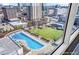 A breathtaking aerial view highlighting the pool, green space, and surrounding city buildings at 250 Pharr Ne Rd # 1618, Atlanta, GA 30305