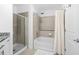 Bright bathroom featuring a shower with a glass enclosure and a soaking tub with tile surround at 250 Pharr Ne Rd # 1618, Atlanta, GA 30305