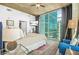 Chic bedroom with floor-to-ceiling windows showcasing city skyline and a cozy seating area for relaxation at 250 Pharr Ne Rd # 1618, Atlanta, GA 30305