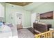 Stylish Bedroom with a soft sofa, a crib, and a changing table for convenience and functionality at 250 Pharr Ne Rd # 1618, Atlanta, GA 30305