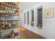 Hallway featuring dark wood floors, a patterned rug, and built-in shelving displaying beverages at 250 Pharr Ne Rd # 1618, Atlanta, GA 30305