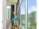 Bright living room offers city views through expansive windows and comfortable seating at 250 Pharr Ne Rd # 1618, Atlanta, GA 30305