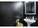 Powder room featuring modern sink, dark accent wall, and decorative plant at 3117 Haynes Park Dr, Lithonia, GA 30038