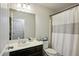 Well-lit bathroom with a vanity, shower curtain, and essential toiletries at 3117 Haynes Park Dr, Lithonia, GA 30038