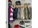 This closet contains a rack full of shirts and pants, as well as shoe and storage boxes on the floor at 3117 Haynes Park Dr, Lithonia, GA 30038