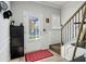 Inviting foyer featuring white trim, wood-look floors, and a staircase with a decorative wood and iron banister at 3117 Haynes Park Dr, Lithonia, GA 30038