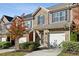 Charming brick townhome featuring a one-car garage, welcoming entryway, and beautifully maintained landscaping at 3117 Haynes Park Dr, Lithonia, GA 30038