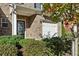 Attractive brick townhome with covered entryway, garage, and well-maintained bushes surrounding the house at 3117 Haynes Park Dr, Lithonia, GA 30038