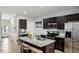 Modern kitchen with granite counters, stainless steel appliances, dark cabinets, and island with seating at 3117 Haynes Park Dr, Lithonia, GA 30038