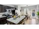 Open kitchen with granite counters, stainless appliances, island with seating, and dining area at 3117 Haynes Park Dr, Lithonia, GA 30038