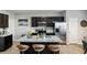 Modern kitchen featuring dark cabinetry, stainless steel appliances, granite countertops, and an island with seating at 3117 Haynes Park Dr, Lithonia, GA 30038