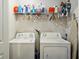 A practical laundry room featuring a washer, dryer, shelving, and an ironing board at 3117 Haynes Park Dr, Lithonia, GA 30038