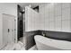 Modern bathroom with a soaking tub, a glass shower, and black-and-white tile at 4201 Brookview Se Dr, Atlanta, GA 30339