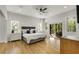 Bright bedroom with a ceiling fan, a sliding glass door to the outside, and hardwood floors at 4201 Brookview Se Dr, Atlanta, GA 30339