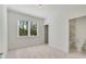 Neutral bedroom with an ensuite bathroom and a large window at 4201 Brookview Se Dr, Atlanta, GA 30339