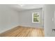 Bright bedroom with gleaming hardwood floors and a tree view from the window at 4201 Brookview Se Dr, Atlanta, GA 30339