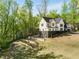 Side view of new construction with manicured lawn, backyard with multiple levels, and a modern elevation at 4201 Brookview Se Dr, Atlanta, GA 30339