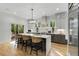 Beautiful kitchen with stainless appliances, gray cabinets, an island with seating, and stone countertops at 4201 Brookview Se Dr, Atlanta, GA 30339