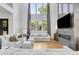 Inviting living room with high ceilings, large windows, fireplace, and comfortable white furniture at 4201 Brookview Se Dr, Atlanta, GA 30339