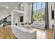 Open living room boasts hardwood floors, high ceilings, large windows, and comfortable seating arrangements at 4201 Brookview Se Dr, Atlanta, GA 30339