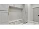 Organized mudroom with built-in storage cabinets, a bench, and stylish tiled floor at 4201 Brookview Se Dr, Atlanta, GA 30339