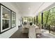 Covered outdoor patio with a dining area and serene views of the surrounding trees at 4201 Brookview Se Dr, Atlanta, GA 30339