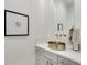 Stylish powder room with a unique gold vessel sink, bright white marble countertop, and modern fixtures at 4201 Brookview Se Dr, Atlanta, GA 30339