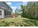 Expansive backyard featuring a deck, a large grassy area, and a storage shed at 8050 Tristan Way, Whitesburg, GA 30185