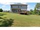Grassy backyard featuring a deck, an expansive green lawn, and privacy landscaping at 8050 Tristan Way, Whitesburg, GA 30185