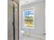 Contemporary bathroom showcasing a glass shower, modern fixtures, and a bright window at 8050 Tristan Way, Whitesburg, GA 30185